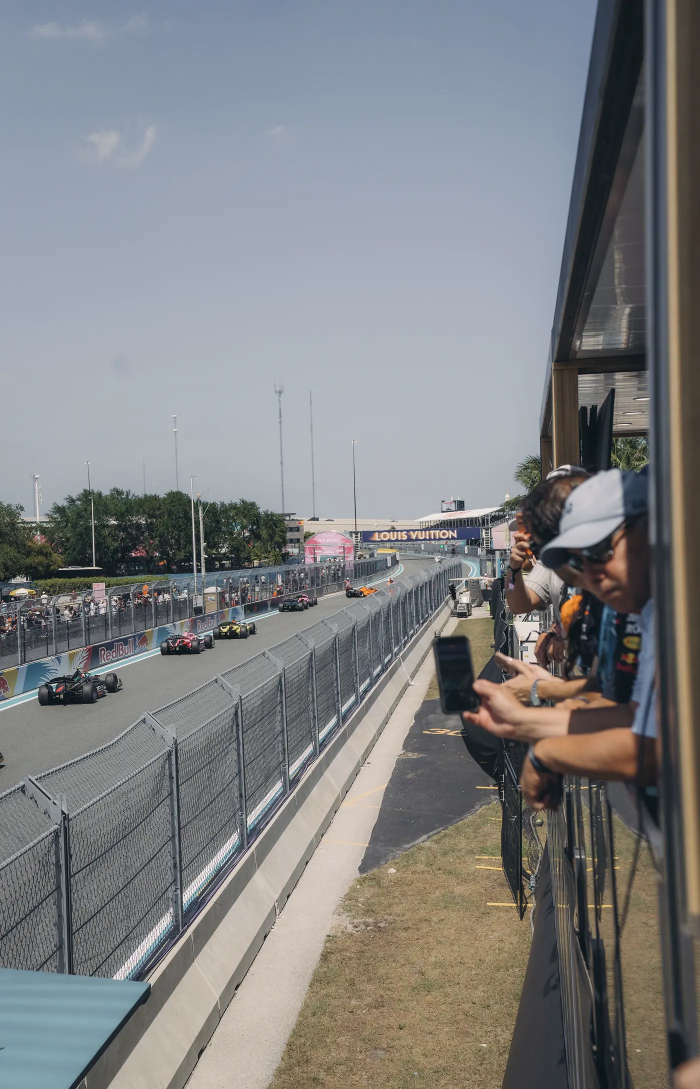 Formula 1 cars on the Miami circuit seen from the GRID House balcony