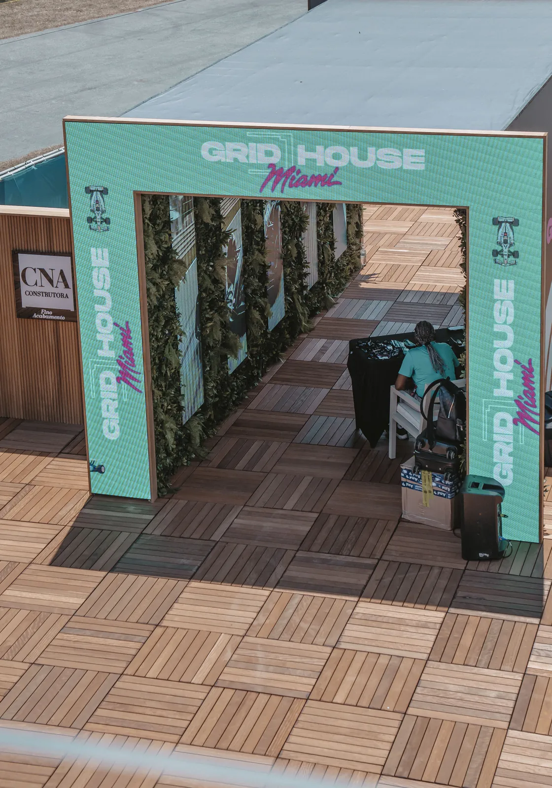 A branded event entrance with a planted archway